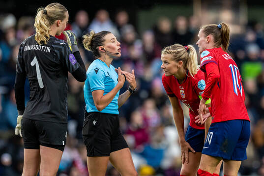 Referee Olatz Rivera Olmedo talks to Ada Hegerberg and