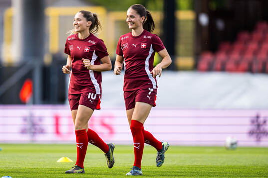 Ramona Bachmann and Naina Inauen of Switzerland warms up