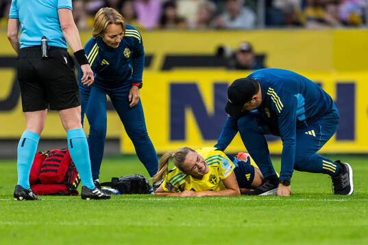 Fridolina Rolfö of Sweden receives medical attention