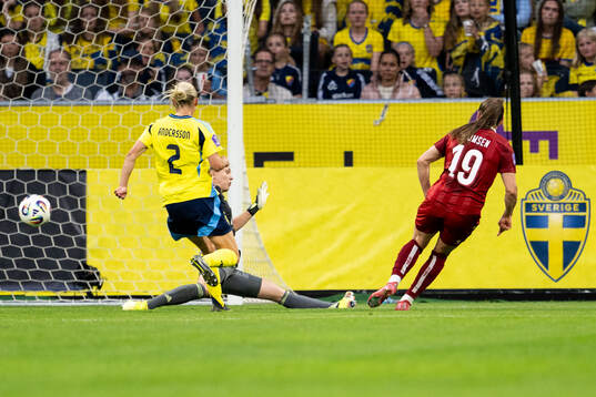 Janni Thomsen of Denmark scores 3-1 behind goalkeeper