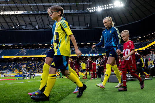 Stina Blackstenius of Sweden with a mascot