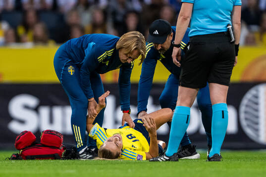 Fridolina Rolfö of Sweden receives medical attention