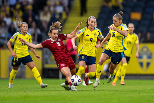 Emma Snerle of Denmark competes for the ball with Kosovare