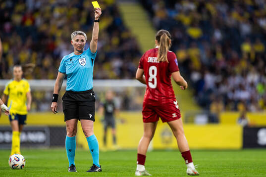 Emma Snerle of Denmark receives a yellow card from referee