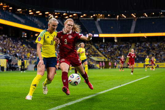 Stina Blackstenius of Sweden and Stine Ballisager of Denmark
