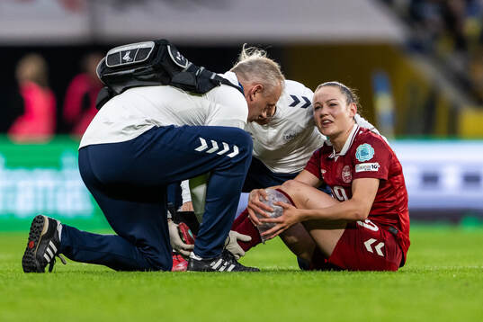 Janni Thomsen of Denmark receives medical attention