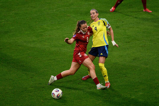 Emma Snerle of Denmark and Kosovare Asllani of Sweden
