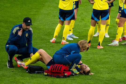 Fridolina Rolfö of Sweden receives medical attention