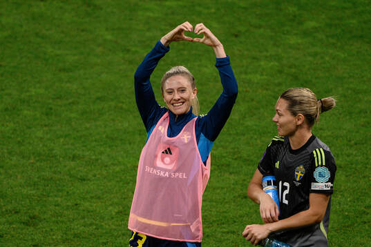Rebecka Blomqvist and goalkeeper Jennifer Falk of Sweden