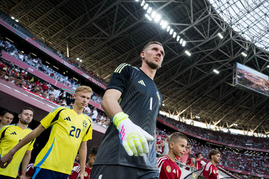 Hugo Larsson and goalkeeper Robin Olsen of Sweden