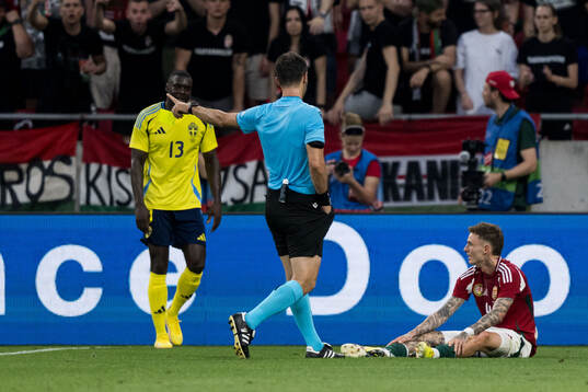Ken Sema of Sweden receives at yellow card from referee