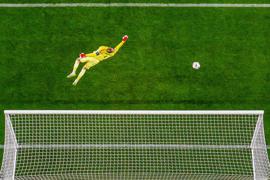 Goalkeeper Gianluigi Donnarumma of Italy as the ball hits