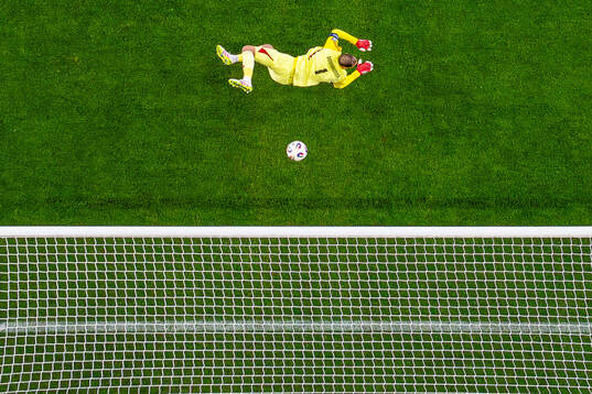 Goalkeeper Gianluigi Donnarumma of Italy as the ball hits