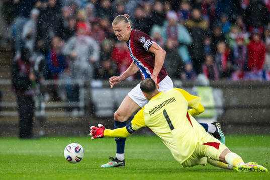 Erling Braut Haaland of Norway scores 3-0 behind goalkeeper
