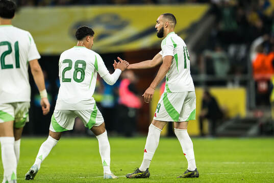 Fares Chaibi and Nabil Bentaleb of Algeria celebrate