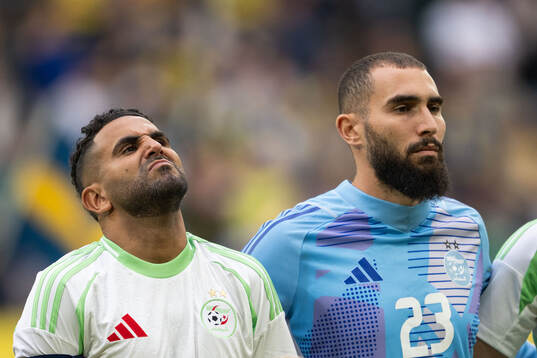 Riyad Mahrez and goalkeeper Anthony Mandrea of Algeria