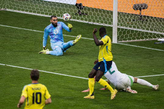 Ken Sema of Sweden scores the 2-0 goal behind goalkeeper