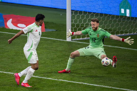 Baghdad Bounedjah of Algeria against goalkeeper Viktor