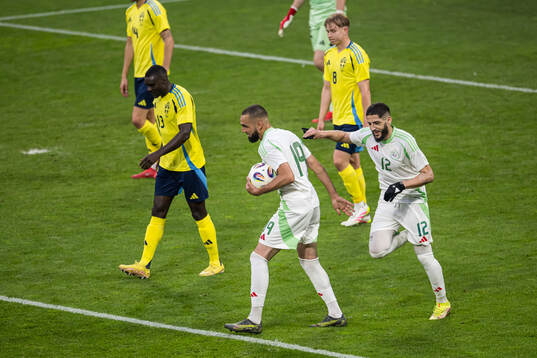 Nabil Bentaleb and Yassine Benzia of Algeria celebrate the