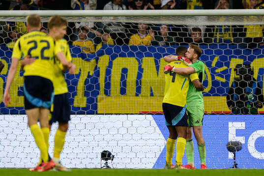 Isak Hien and goalkeeper Viktor Johansson of Sweden