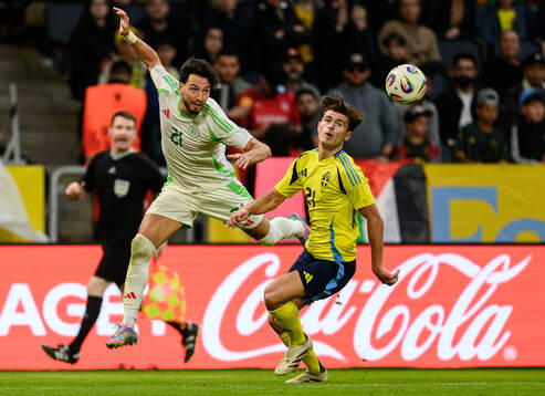 Ramy Bensebaini of Algeria and Besfort Zeneli of Sweden
