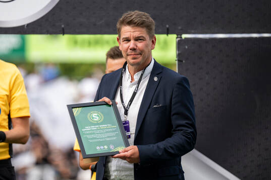 Landskronas klubbchef Karl-Johan Olsson tar emot ett diplom