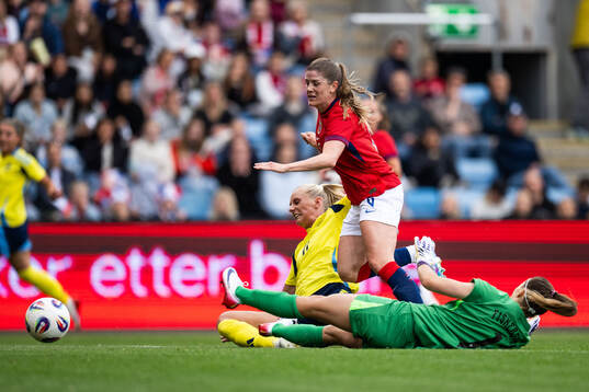 Stina Blackstenius of Sweden scores 0-1 behind Maren Mjelde