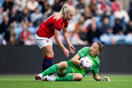Thea Bjelde and goalkeeper Cecilie Fiskerstrand of Norway