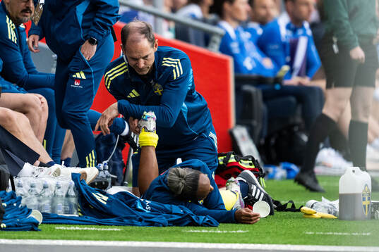Madelen Janogy of Sweden receives medical attention