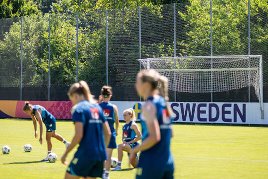 A board at the pitch of the Swedish women's national