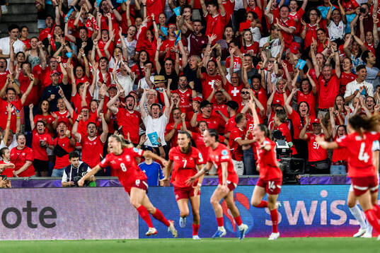 Fan of Switzerland celebrate 1-0 by Nadine Riesen of