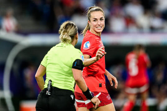 Referee Alina Pesu and Lia Wälti of Switzerland