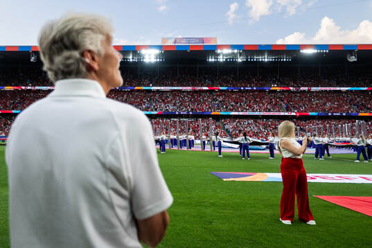 Spectators is seen behind Head coach Pia Sundhage of