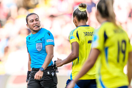 Referee Edina Alves and Madelen Janogy of Sweden