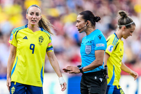 Kosovare Asllani of Sweden and Referee Edina Alves