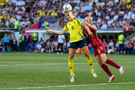 Stina Blackstenius of Sweden and Stine Ballisager of Denmark