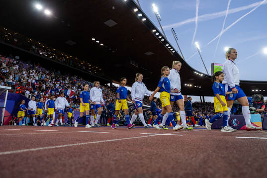 Players of England and of France enter the arena