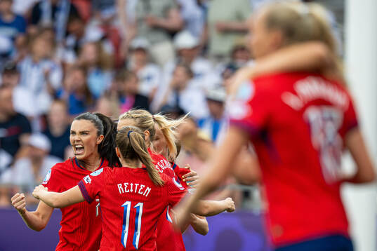 Ingrid Syrstad Engen of Norway celebrates with teammates
