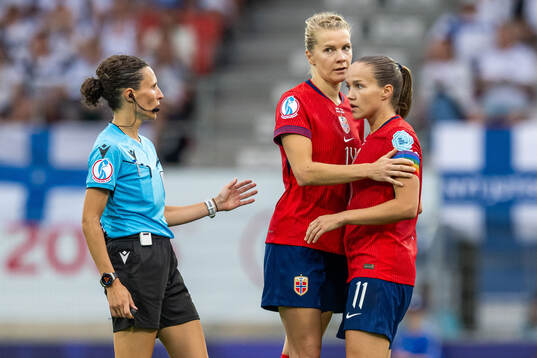Referee Silvia Gasperotti, Ada Hegerberg of Norway and Guro