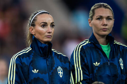 Kosovare Asllani and goalkeeper Jennifer Falk of Sweden
