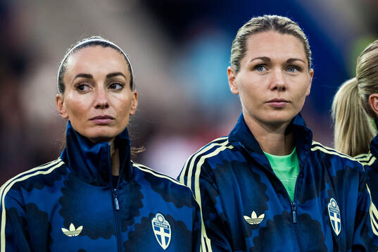 Kosovare Asllani and goalkeeper Jennifer Falk of Sweden