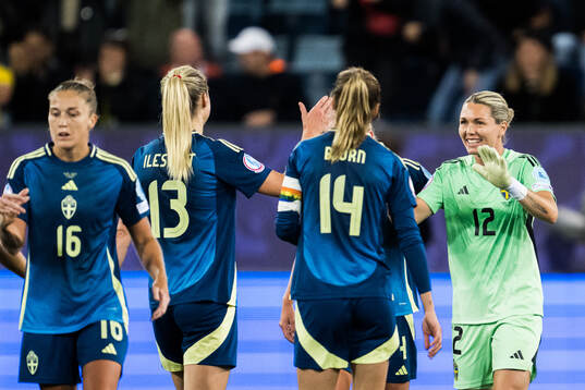 Goalkeeper Jennifer Falk of Sweden celebrate with teammates