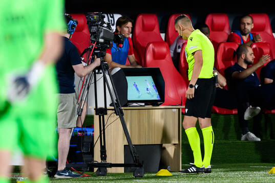 Referee Igor Stojchevski check the VAR screen