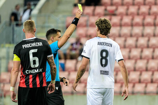Referee Bence Csonka and Silas Andersen of Häcken