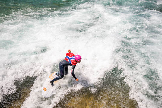 A surfer with a Norwegian flag