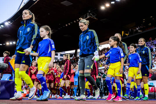 Kosovare Asllani and goalkeeper Jennifer Falk of Sweden