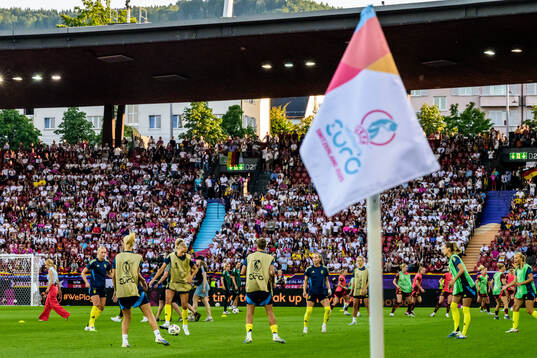 Players of Sweden varm up behind the flag for the UEFA