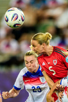 Alessia Russo of England and Rhiannon Roberts of Wales