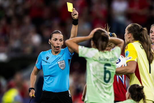 Manuela Giugliano of Italy is shown a yellow card from