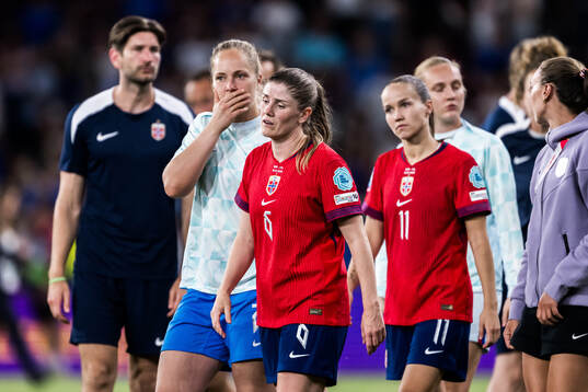 Maren Mjelde and Guro Reiten of Norway looks dejected